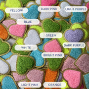 a close up of many different colored hearts