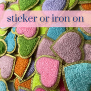 a pile of colorful iron - on patches with the words sticker or iron on
