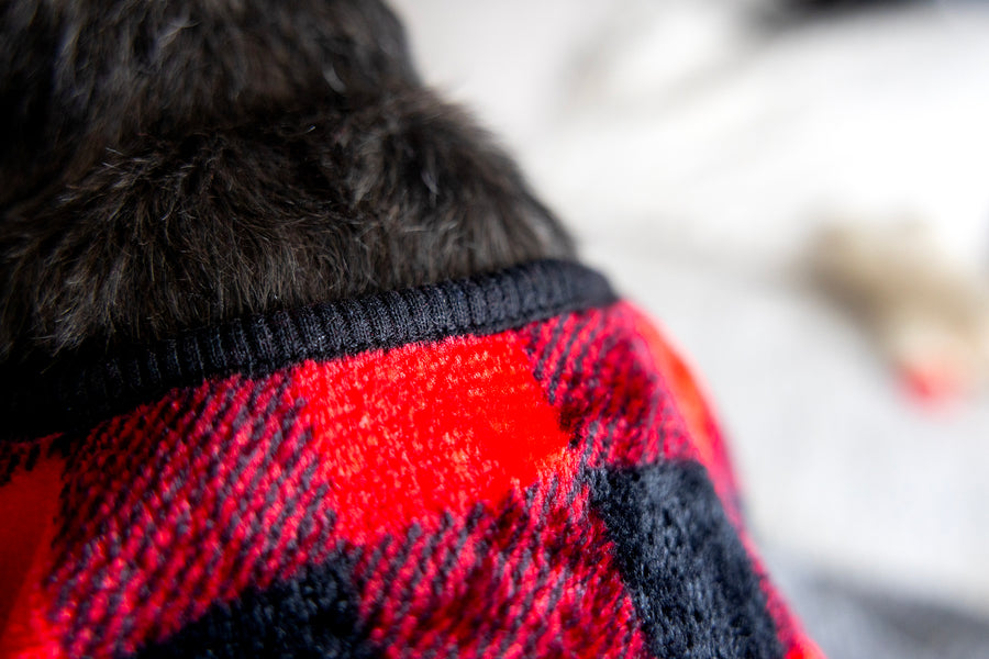 Close up of material, Plaid PJs for Pet, showing hem detail in black