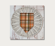 plaid dog bandana flat lay, folded, showing plaid side with orange, black, green, yellow colors