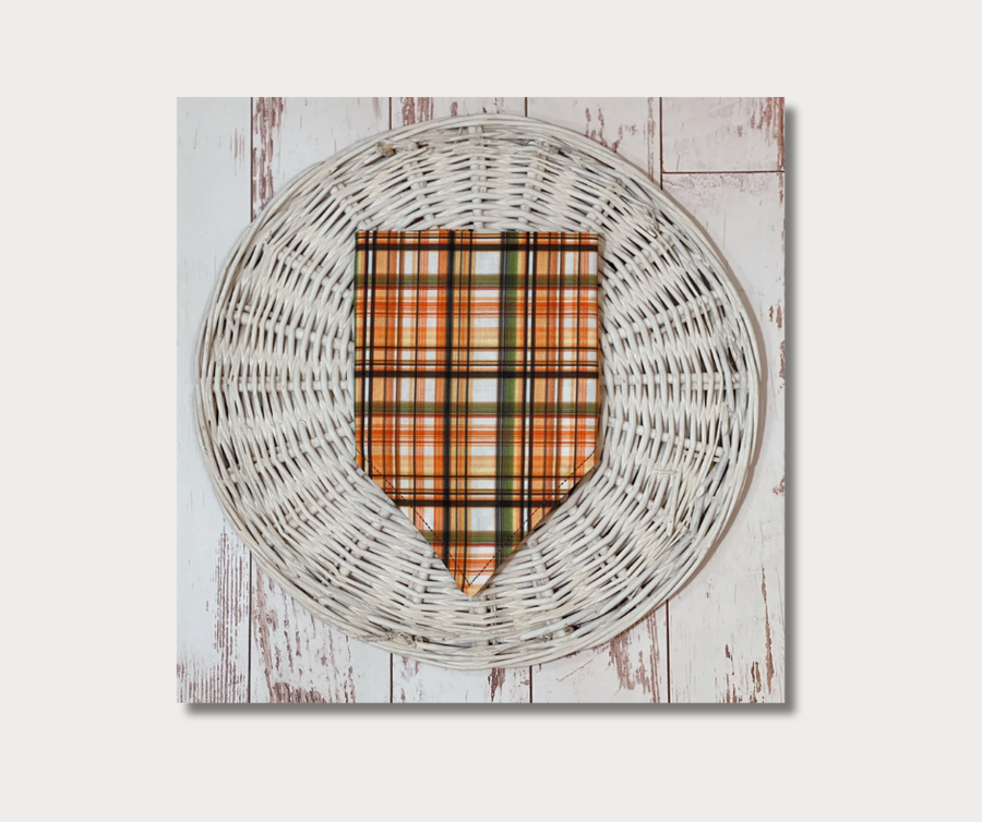 plaid dog bandana flat lay, folded, showing plaid side with orange, black, green, yellow colors