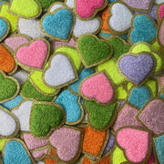 a bunch of heart shaped cookies on a table