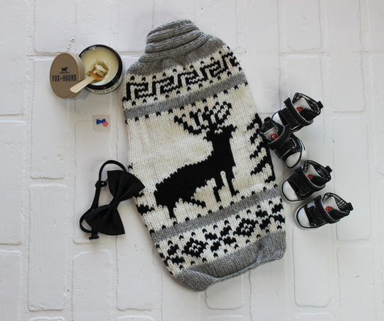 Large dog sweater with black and white design, flatlay shows dog accessories and elk design