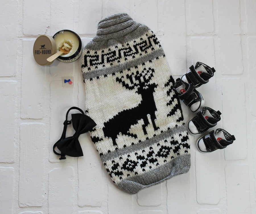Large dog sweater with black and white design, flatlay shows dog accessories and elk design