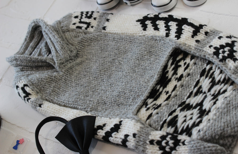 close up of underside of dog sweater, main color is gray