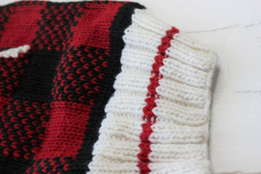 Close up of bottom band on wool knit sweater for dog.